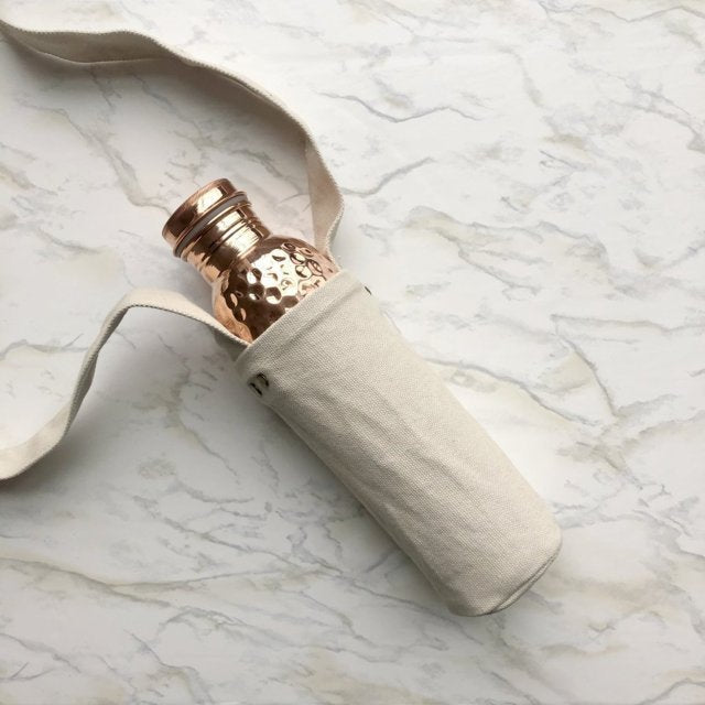 Copper H2O water bottle sling holding hammered copper water bottle